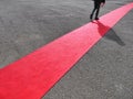 Walking persons on red carpet close view on legs