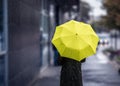 Walking on rainy day with yellow umbrella