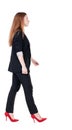 Walking red head business woman. Royalty Free Stock Photo