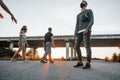 Walking on the road. Group of young cheerful friends having fun together. Party outdoors Royalty Free Stock Photo