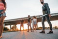 Walking on the road. Group of young cheerful friends having fun together. Party outdoors Royalty Free Stock Photo