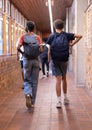 Walking in school hallway, students with backpacks heading to class Royalty Free Stock Photo