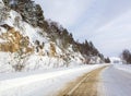 walking through the snow-covered mountain space and the adjacent forest and road.