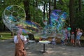 Svetlogorsk, Russia - June 08, 2019: Magician entertains tourists with bubbles in city park Royalty Free Stock Photo