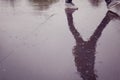 Walking student. Reflection in the wet surface. Royalty Free Stock Photo