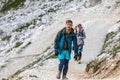 Walking summer trekking in the Dolomites. People in the mountains. Mountain view Italian Alps.