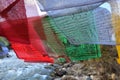 walking suspension bridge over the river with colorful prayer flags in Bhutan