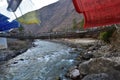 walking suspension bridge over the river with colorful prayer flags in Bhutan