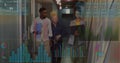 Walking team analyzing data in office corridor with blue folder, laptop, translucent charts, graphs Royalty Free Stock Photo