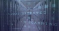 Walking technician inspecting server racks at cold aisle, with blinking lights and scan overlay Royalty Free Stock Photo