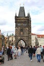 The walking tourists pass through an acre and come to Karlov Bridge. Royalty Free Stock Photo