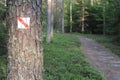 Walking trail marks and signs on trees showing direction for hikers in forest Royalty Free Stock Photo