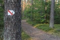 Walking trail marks and signs on trees showing direction for hikers in forest Royalty Free Stock Photo