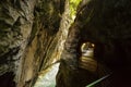 Walking trail through narrow, dark and deep Aare canyon Royalty Free Stock Photo