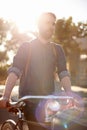 Walking, transport and man in road with bicycle for exercise, commute and cycling in morning. Travel, lens flare and