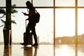 Walking traveler with suitcase, passenger for tour in the airport terminal for air traveling Royalty Free Stock Photo