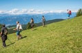 Walking walkers admire the Dolomite mountains landscape. South Tyrol, Italy