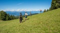 Walking walkers admire the Dolomite mountains landscape. South Tyrol, Italy