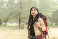 Beautiful Asian backpacker woman walking into the forest