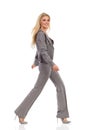 Walking Woman In Gray Suit Is Smiling And Looking At Camera Royalty Free Stock Photo