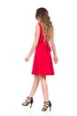 Walking Woman In Red Dress And High Heels. Rear Side View. Royalty Free Stock Photo