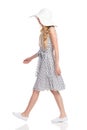 Walking Woman In White Dotted Dress, Sun Hat And Sneakers Royalty Free Stock Photo