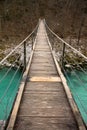 Walking on wooden footbridge crossing over turquoise river of soca, triglav national park, slovenia Royalty Free Stock Photo
