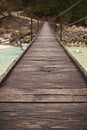 Walking on wooden footbridge crossing over turquoise river of soca, triglav national park, slovenia Royalty Free Stock Photo