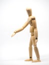 Walking wooden puppet on the white background Isolated Background. The arm of the puppet protrudes to the front. Move flow Royalty Free Stock Photo