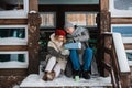 Walking through the woods in winter a man and a woman found a house and sat on the porch to drink coffee