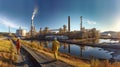 Walking workers in work clothes in a refinery with pipes and machinery Royalty Free Stock Photo