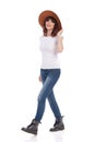 Walking Young Woman In White T-Shirt And Brown Hat Royalty Free Stock Photo