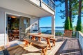 Walkout deck with wooden table set and amazing water view. Royalty Free Stock Photo