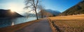 Walkway along achensee lake shore in november, at sunset. austrian landscape