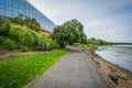 Walkway along the Potomac River and modern office building in Al