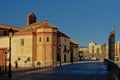 Walkway along river Guadalmedina with Santo Domingo church on a sunny day, Malaga, Spain