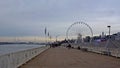 Walkway along river Scheldt with ferris wheel in the city of Antwerp