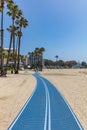 Walkway blue color on the sandy beach. Sunny spring day Royalty Free Stock Photo