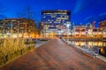 Walkway and buildings along Pratt Street at night, in the Inner Harbor, Baltimore, Maryland Royalty Free Stock Photo