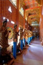 Walkway in Chinese Buddhist temple, Wat Metta Dharma Bodhiyan, with wooden statues of Bodhisattvas, Kanchanaburi