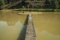 Walkway going to a small island in garden pond Royalty Free Stock Photo