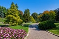 Walkway, green grass and colorful trees at Valentino park in Turin, Italy.