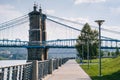 Walkway and the John A. Roebling Suspension Bridge, seen at Smale Riverfront Park, in Cincinnati, Ohio Royalty Free Stock Photo