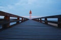 Walkway and lighthouse at sunset Royalty Free Stock Photo