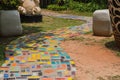 The walkway is made of cement and Colorful Brick on the grass in the garden Royalty Free Stock Photo
