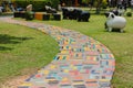 The walkway is made of cement and Colorful Brick on the grass in the garden Royalty Free Stock Photo