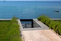 A walkway of marble tiles and a stone staircase with lavender and blue sea. Royalty Free Stock Photo