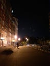 Walkway in the night, city lights