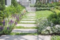 Walkway in the park and beautiful bushes and small flowers