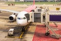 Walkway for passengers boarding plane parked at the Don Muang international airport is a major international Thailand Royalty Free Stock Photo